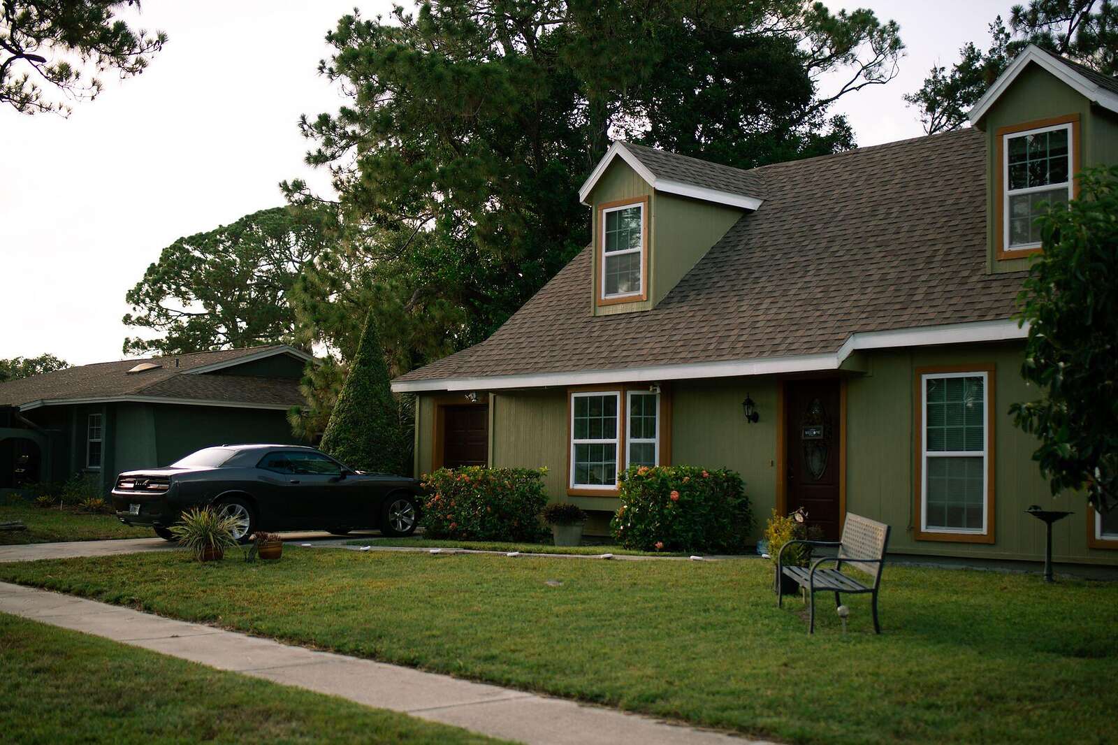A single-story mid-century ranch house on a shaded lot